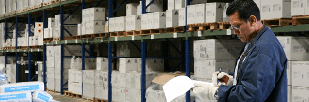 Fresno Chemical Solutions Logistics - Photo of man in warehouse reading his clipboard
