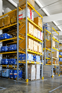 Improving Chemical Warehouse EH&S Management - Palisades Logistics: Photo of chemicals stacked in a chemical warehouse