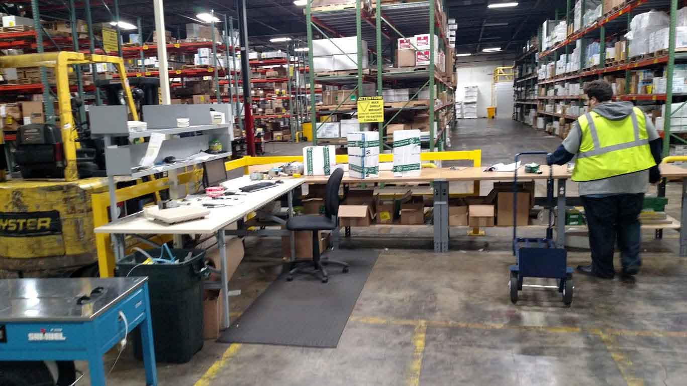 Philadelphia fulfillment - Photo of warehouse employee pick-packing products for order fulfillment inside one of the Philadelphia public warehouses available through Palisades Logistics