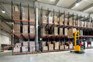 Photo of a Columbus public warehouse facility featuring a forklift stacking pallets on shelving