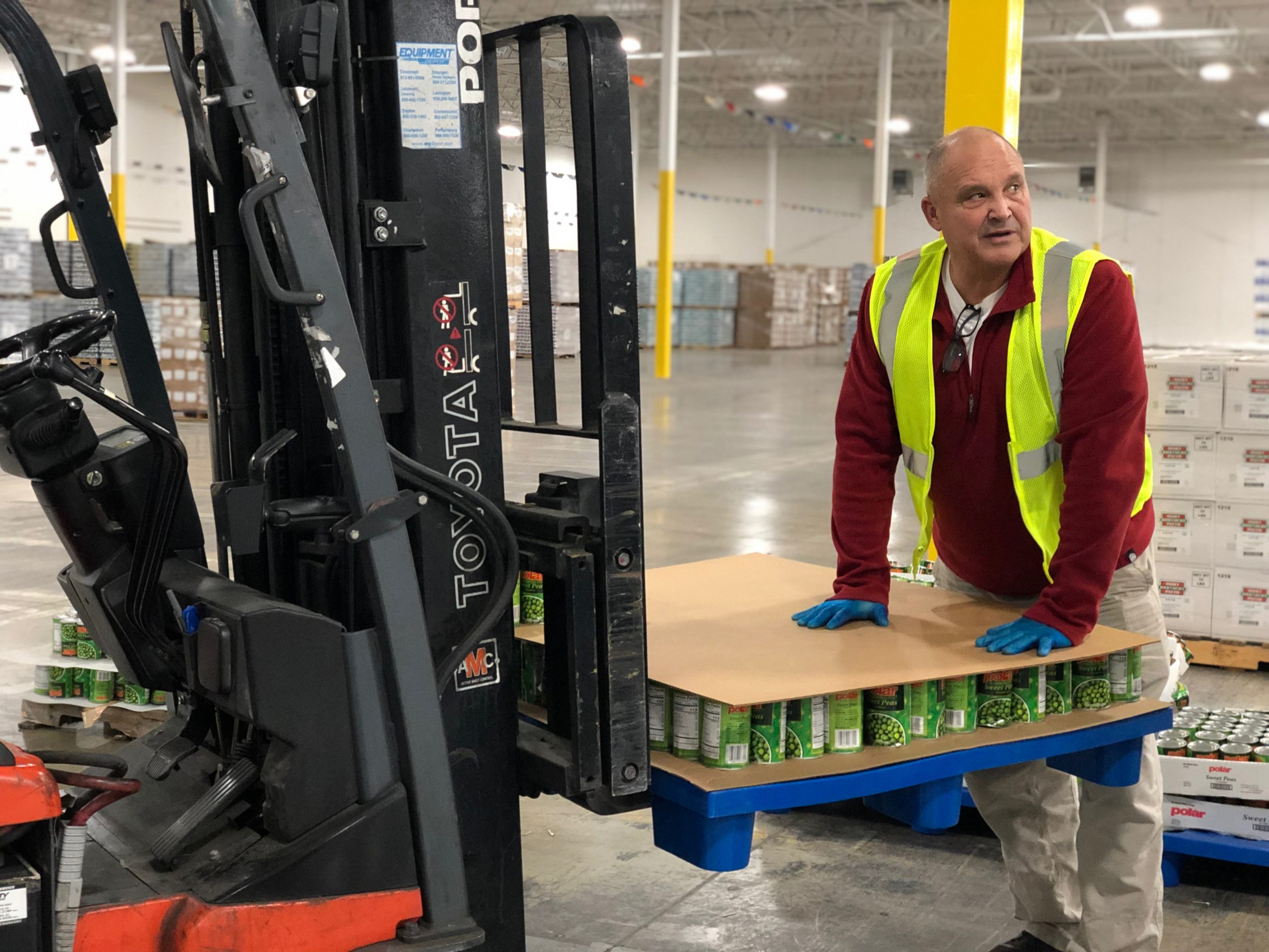 Cincinnati 3PL; photo of forklift operator loading products onto lift for movement through Cincinnati public warehouse