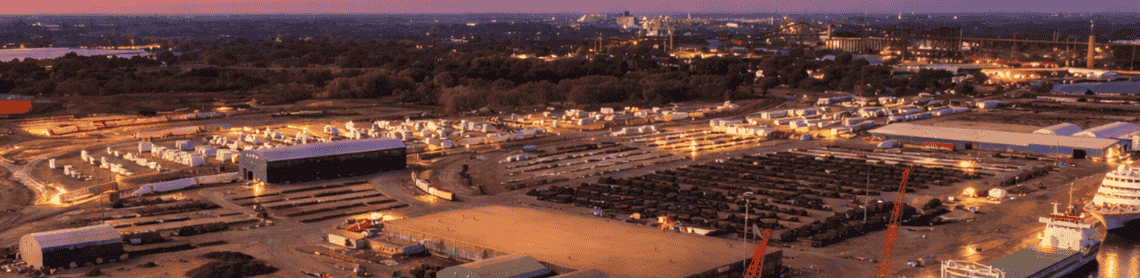 Chicago intermodal port at dusk with cargo ships and warehouse yard, representing 3PL and 3rd party warehouse distribution services.